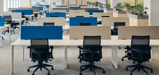 Modern open-plan office space featuring clean workstations, ergonomic chairs, and sanitized carpets provided by professional office cleaning services in Omaha, NE.