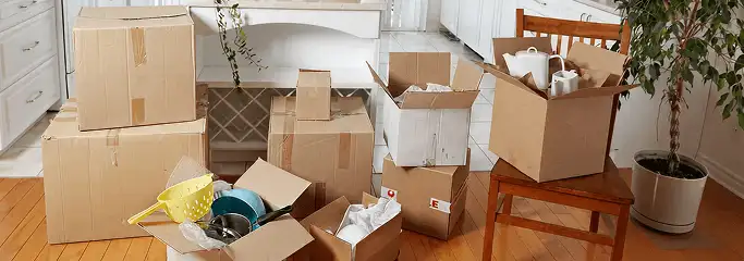 Packed moving boxes and household items in a kitchen before move-out or move-in cleaning, Omaha, NE.